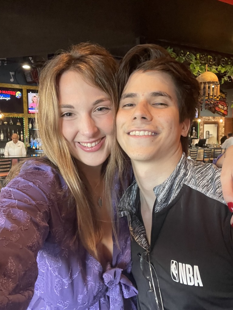 Jade and Juan smiling together during a dinner date