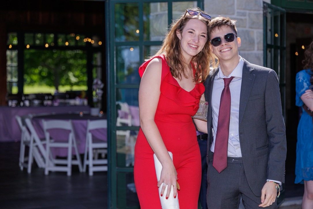 Jade and Juan dressed up together outside a wedding venue
