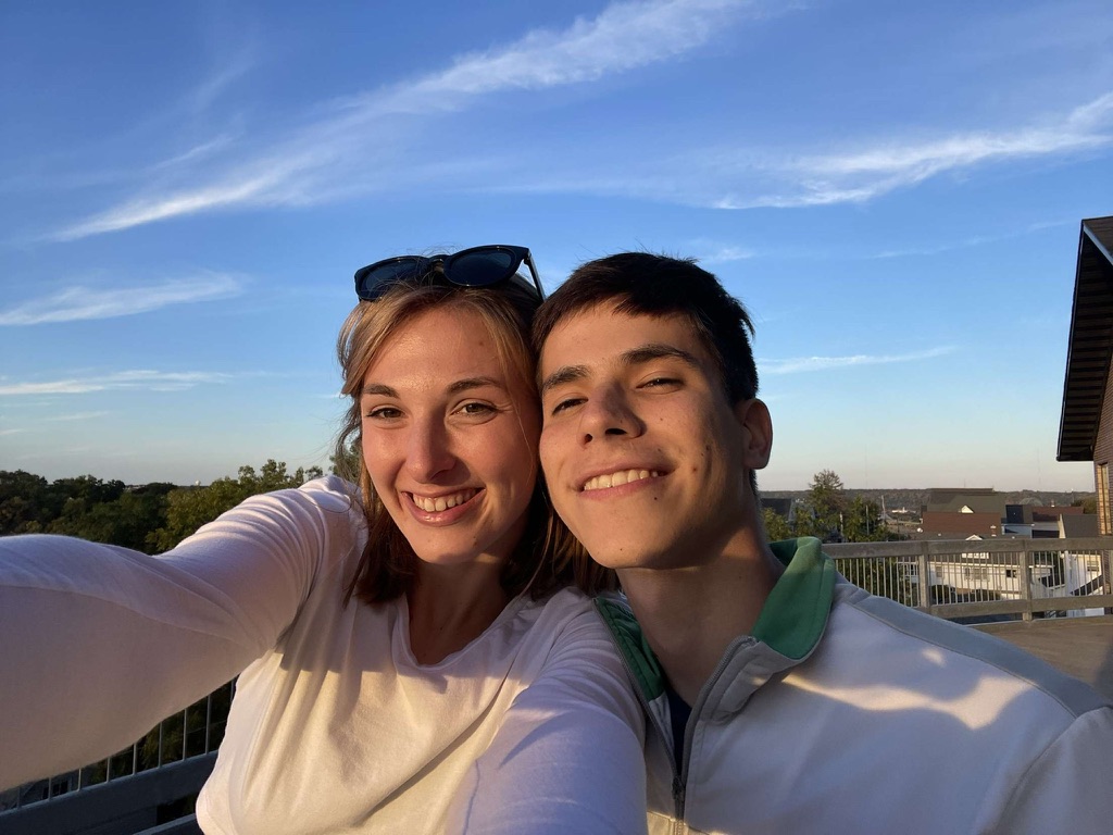 Jade and Juan taking a rooftop selfie at sunset