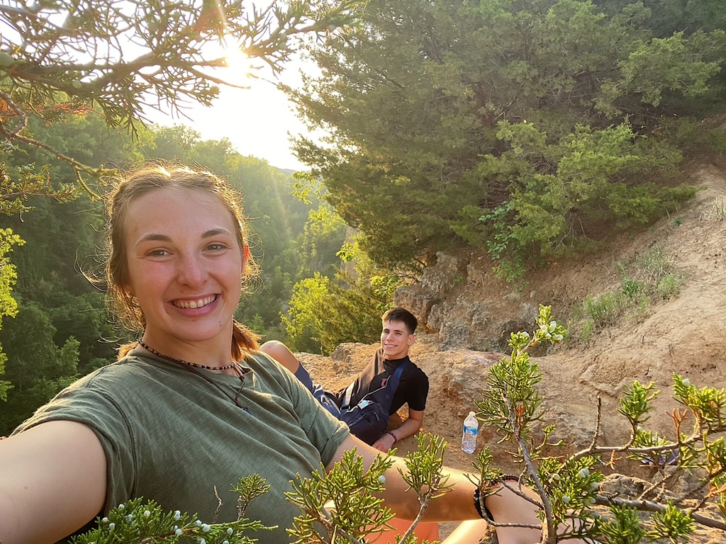 Jade and Juan resting together during a sunset hike
